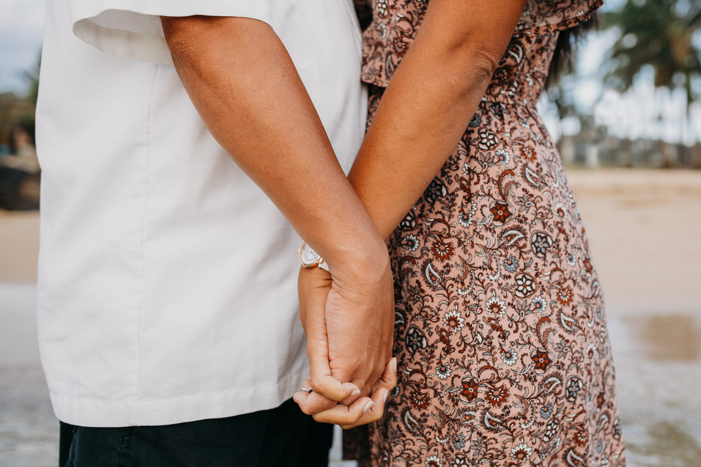 Close up of couple holding hands during their Kauai anniversary photoshoot by Liz Koston.