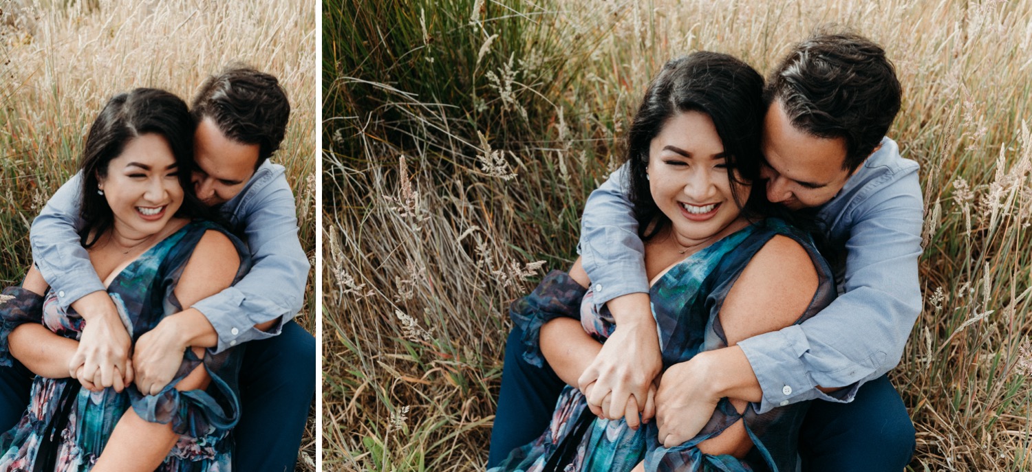 Two images of a couple sitting in a grassy field. The man hugs the smiling woman from behind during a Rodeo Beach engagement photoshoot. 