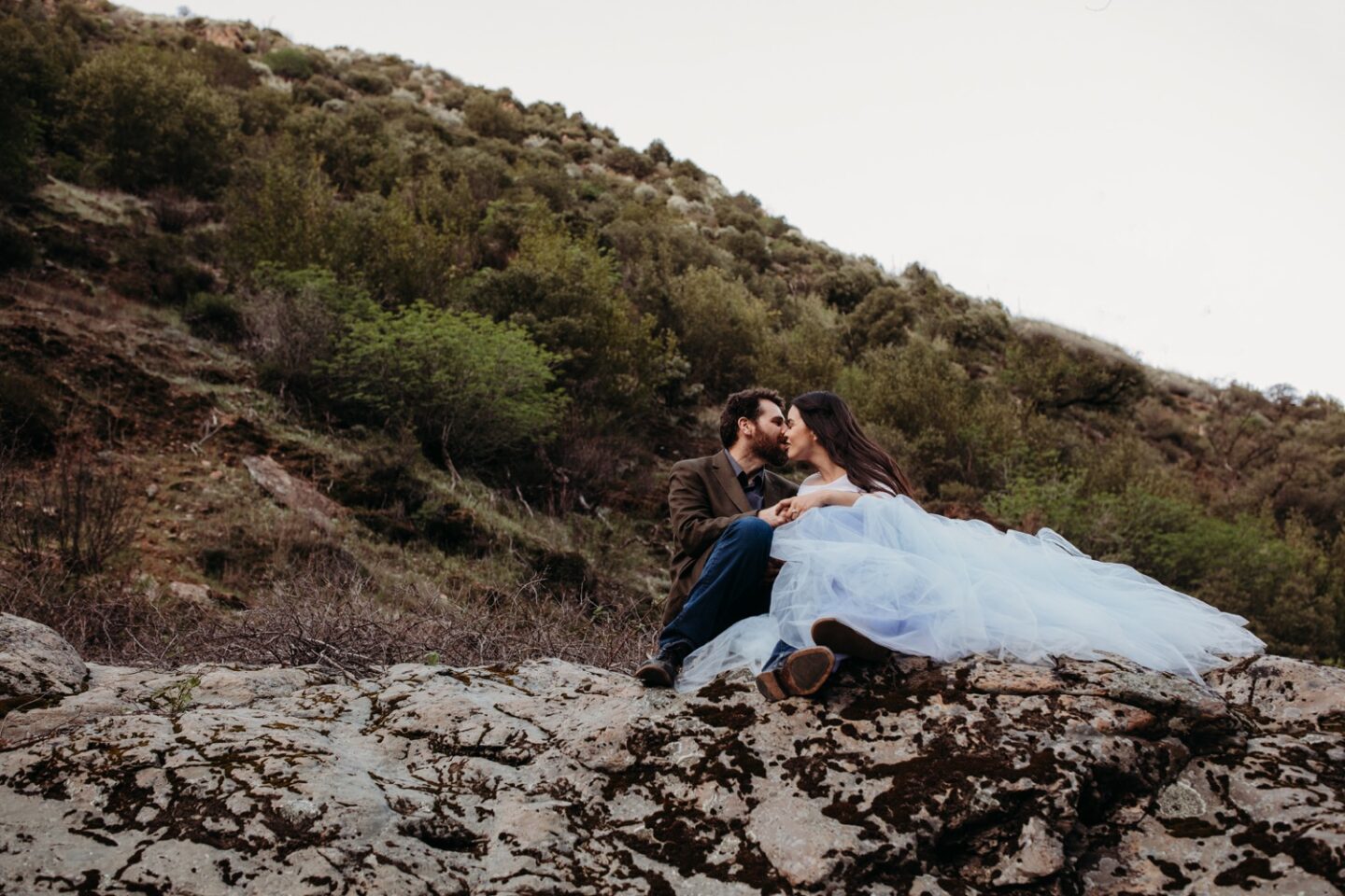 Couple kisses on a hiking trail during their American River engagement photos.