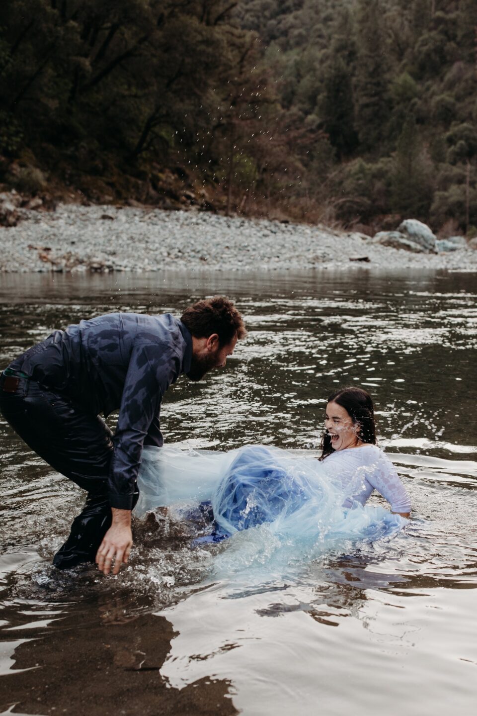 Couple falls in the American River during their river engagement photoshoot in Sacramento.