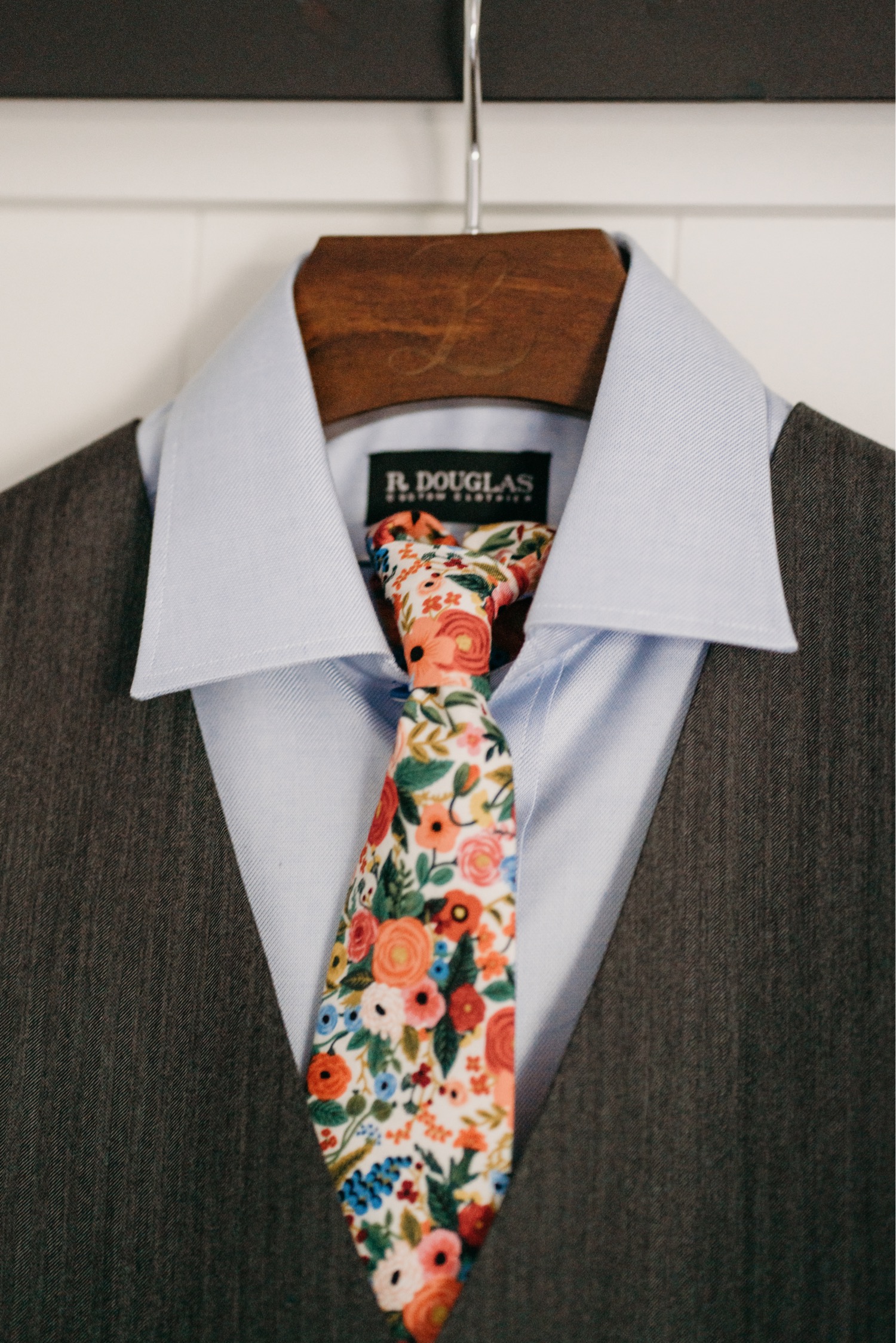 Suit with floral tie on a hanger.