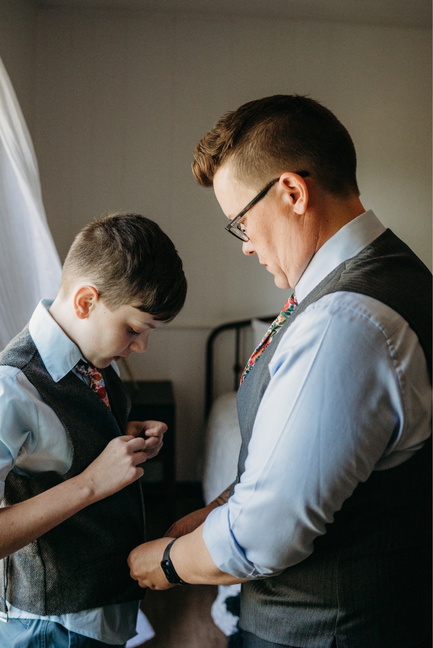 Bride helps her son get dressed for the wedding. Liz Koston Photography.