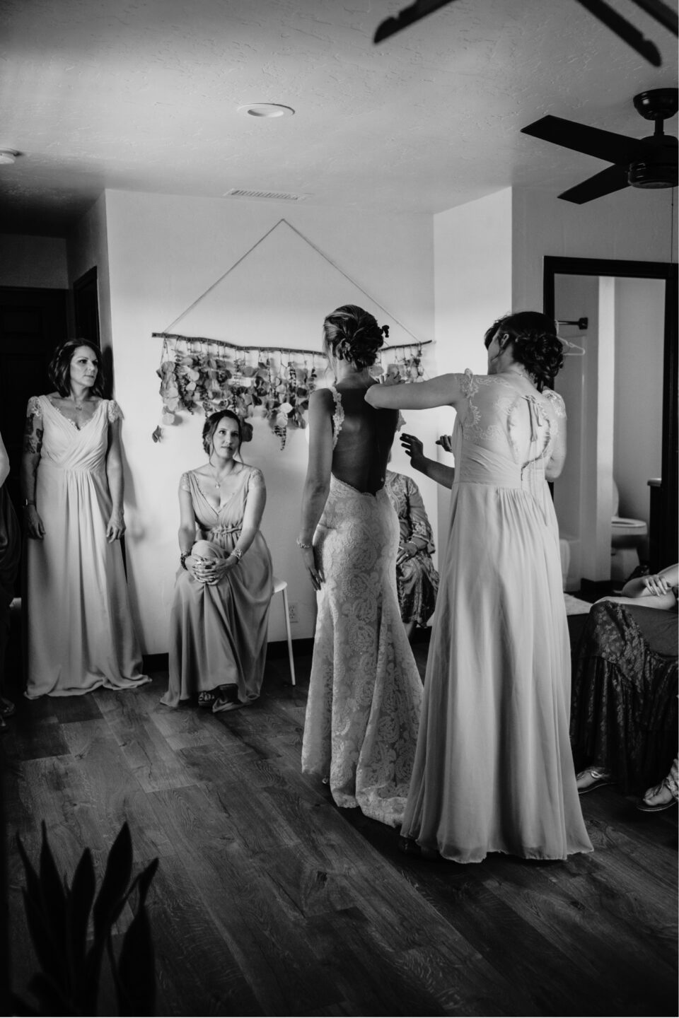 Bride's bridesmaids add finishing touches during their pre-wedding photoshoot. Liz Koston Photography.