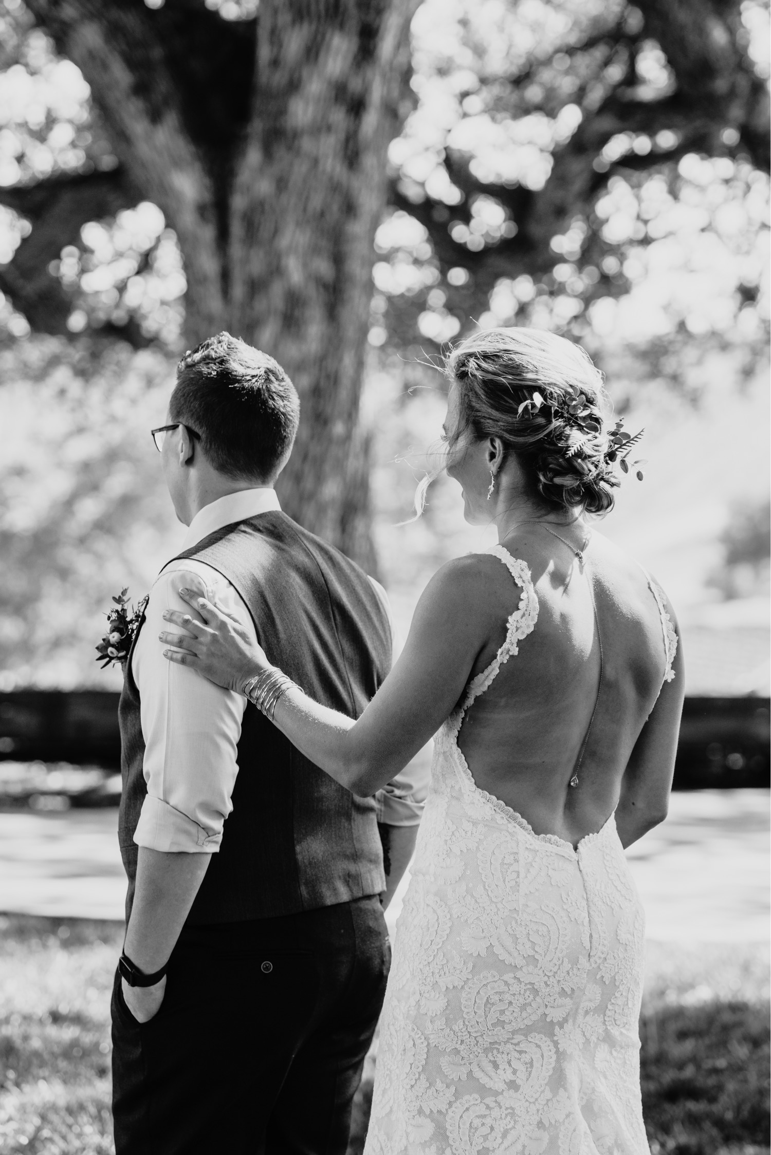 Bride taps her bride on the shoulder for a first look. Liz Koston Photography.
