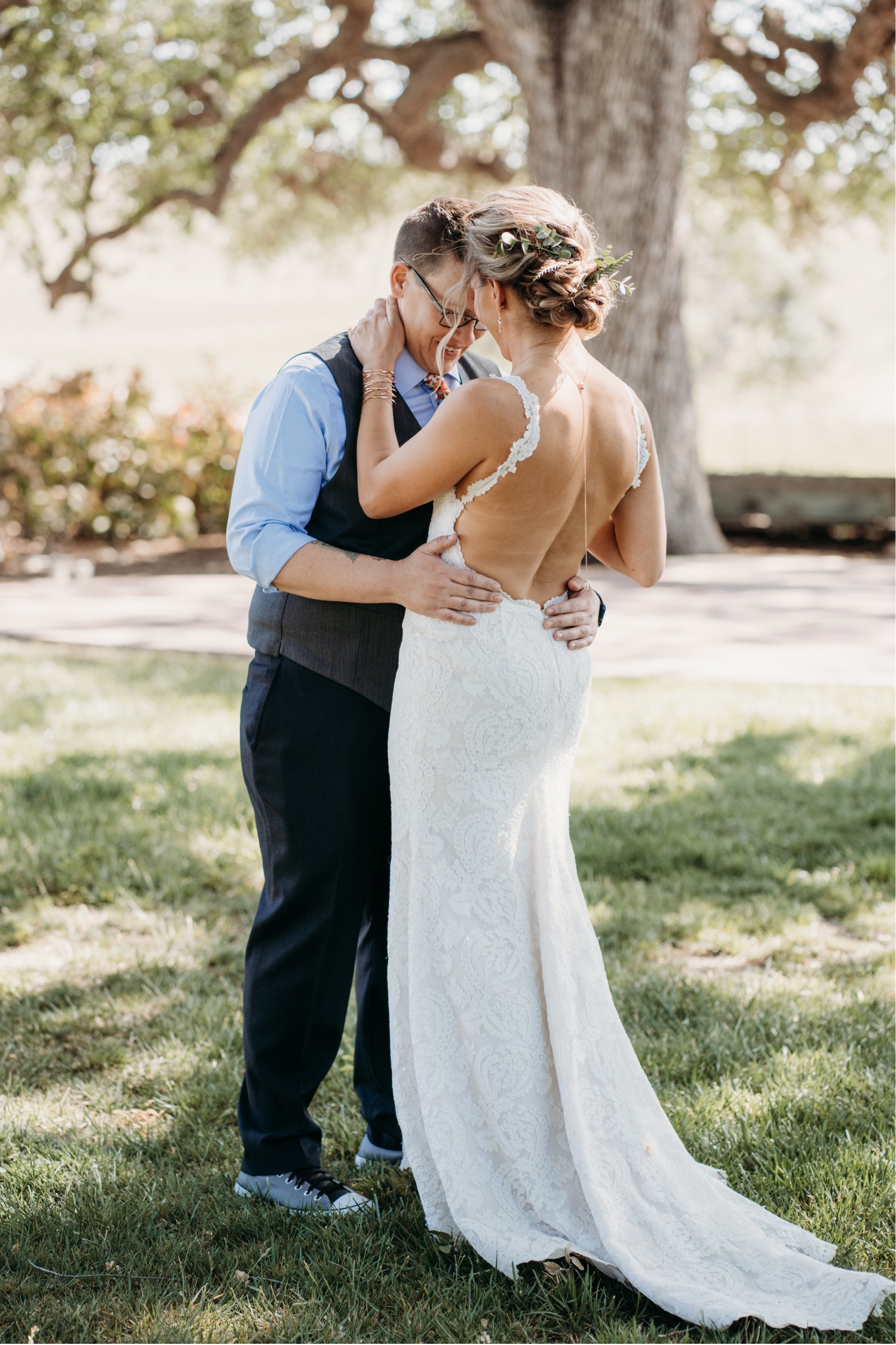 Brides hug each other after a first look photoshoot before their California winery wedding. Liz Koston Photography.