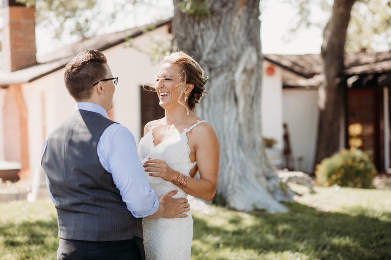 Brides laugh and smile at each other before they get married. Liz Koston Photography.