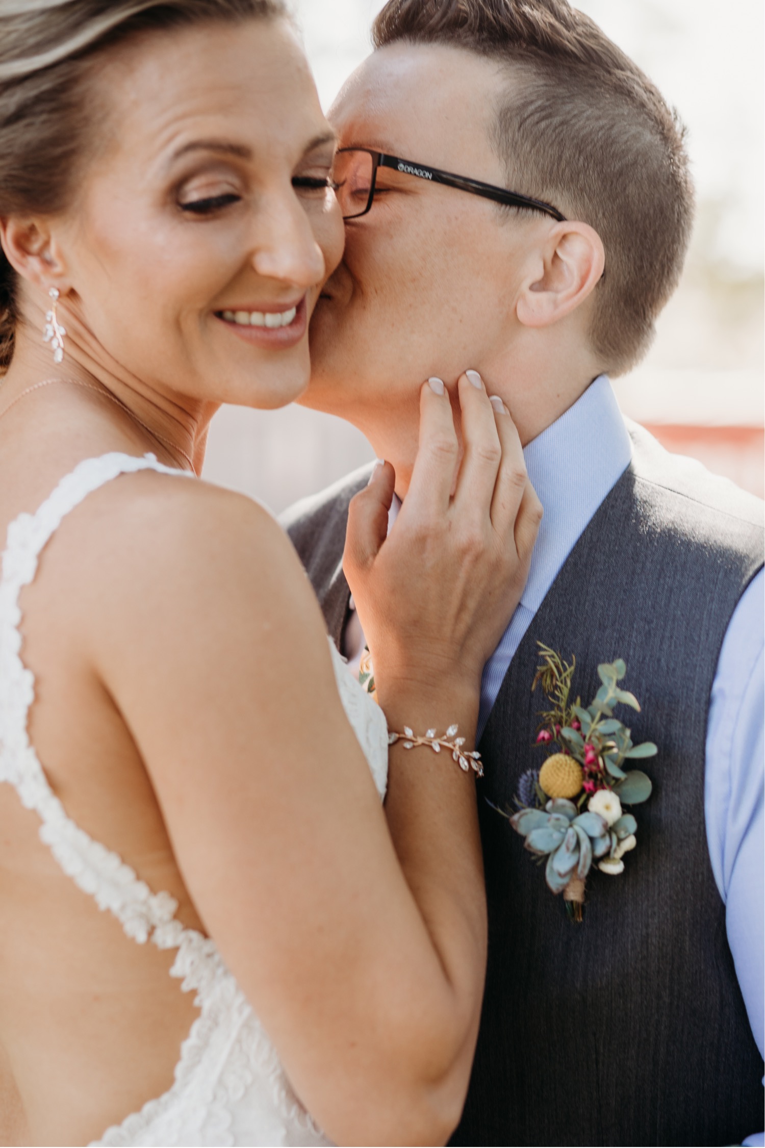 Bride kisses bride on the cheek before their Paso Robles wedding. Liz Koston Photography.
