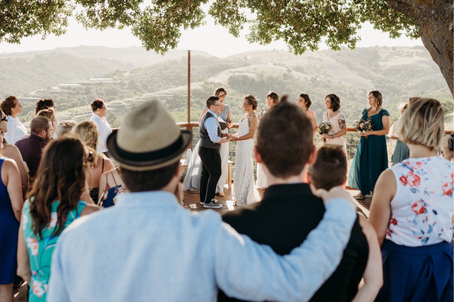 Brides exchange vows overlooking a Paso Robles winery. Liz Koston Photography.
