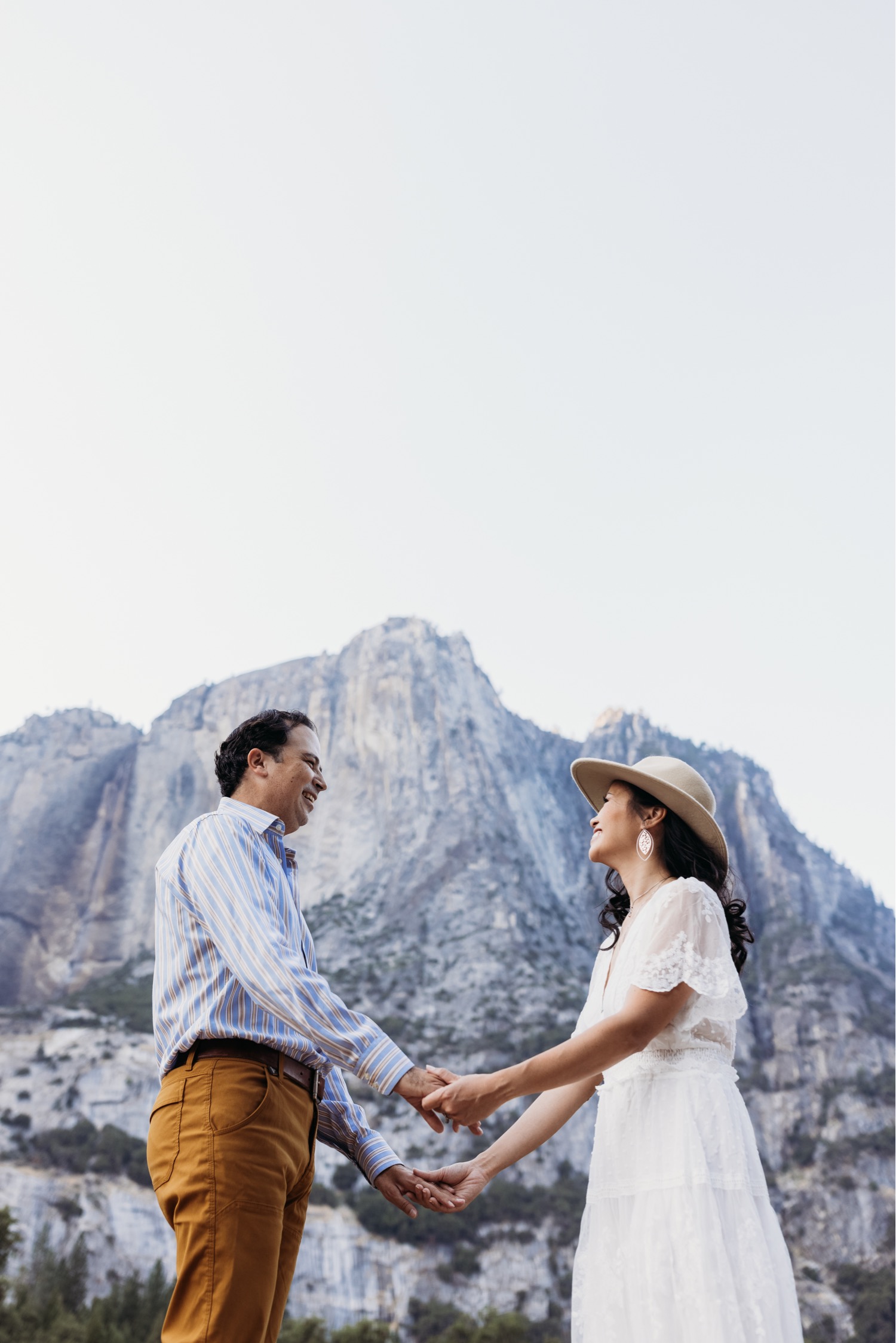 Couple smiling and holding hands on their couples engagement photoshoot in Yosemite National Park