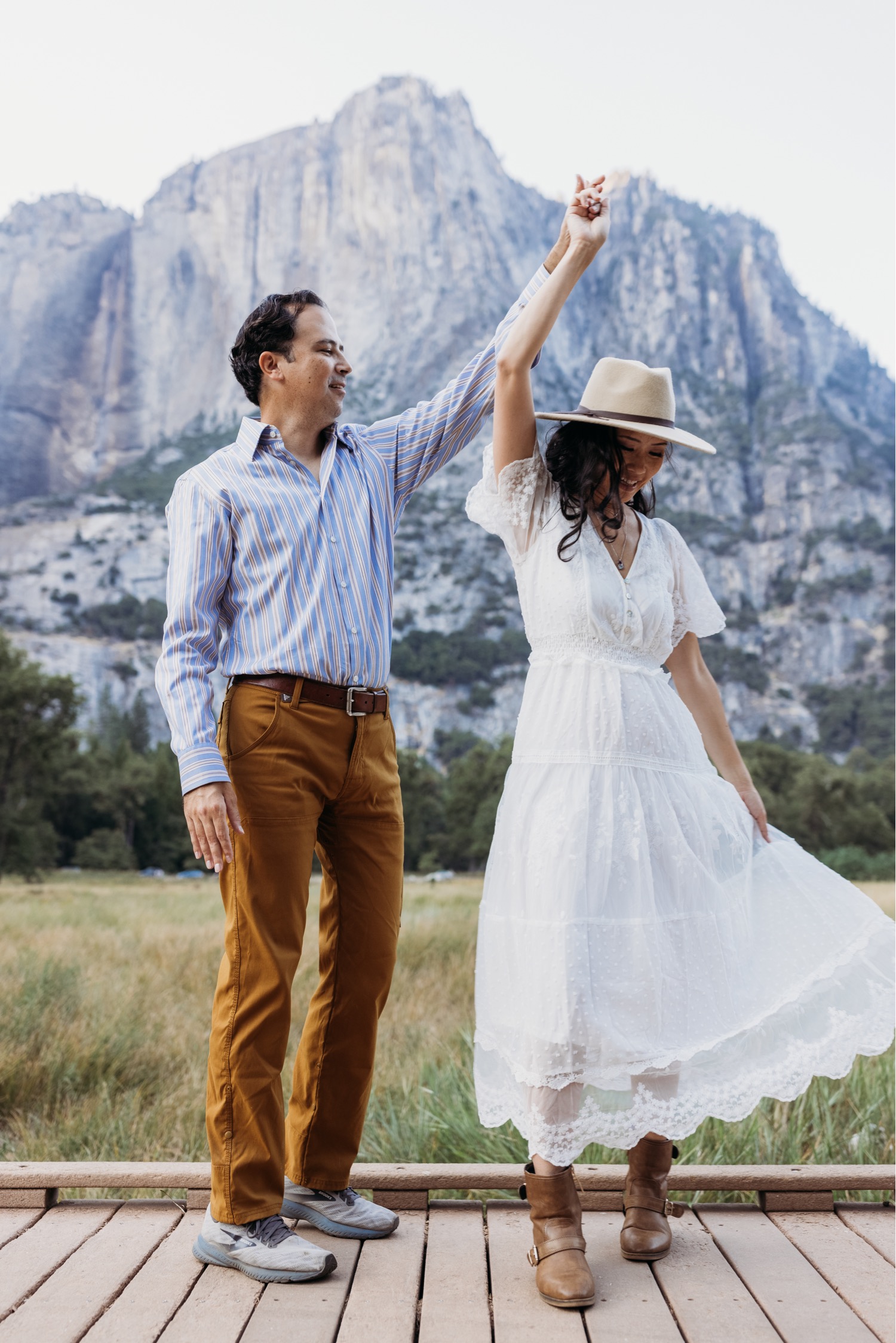 Man twirls wife in Yosemite on their adventurous couples photoshoot