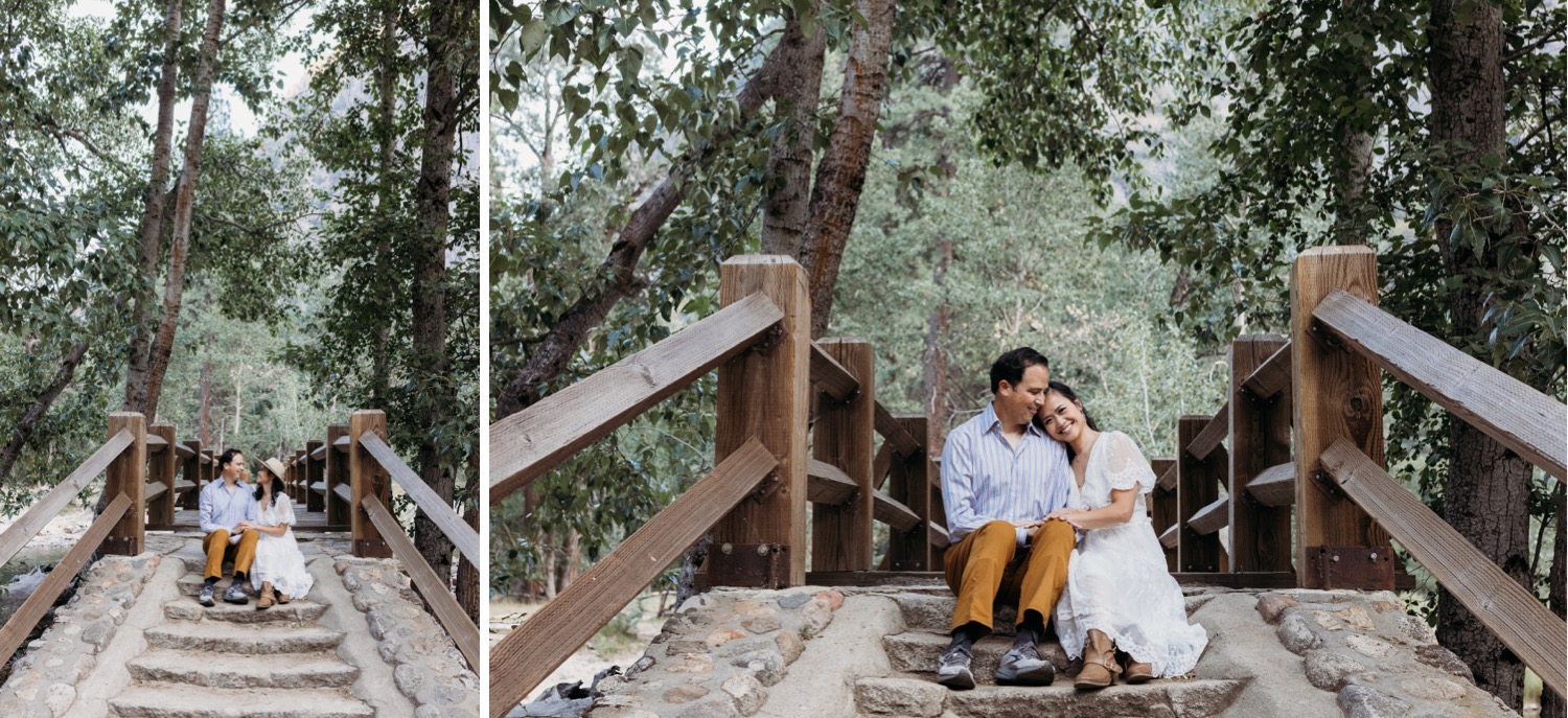 couple sits on steps surrounded by tall trees in Yosemite National Park