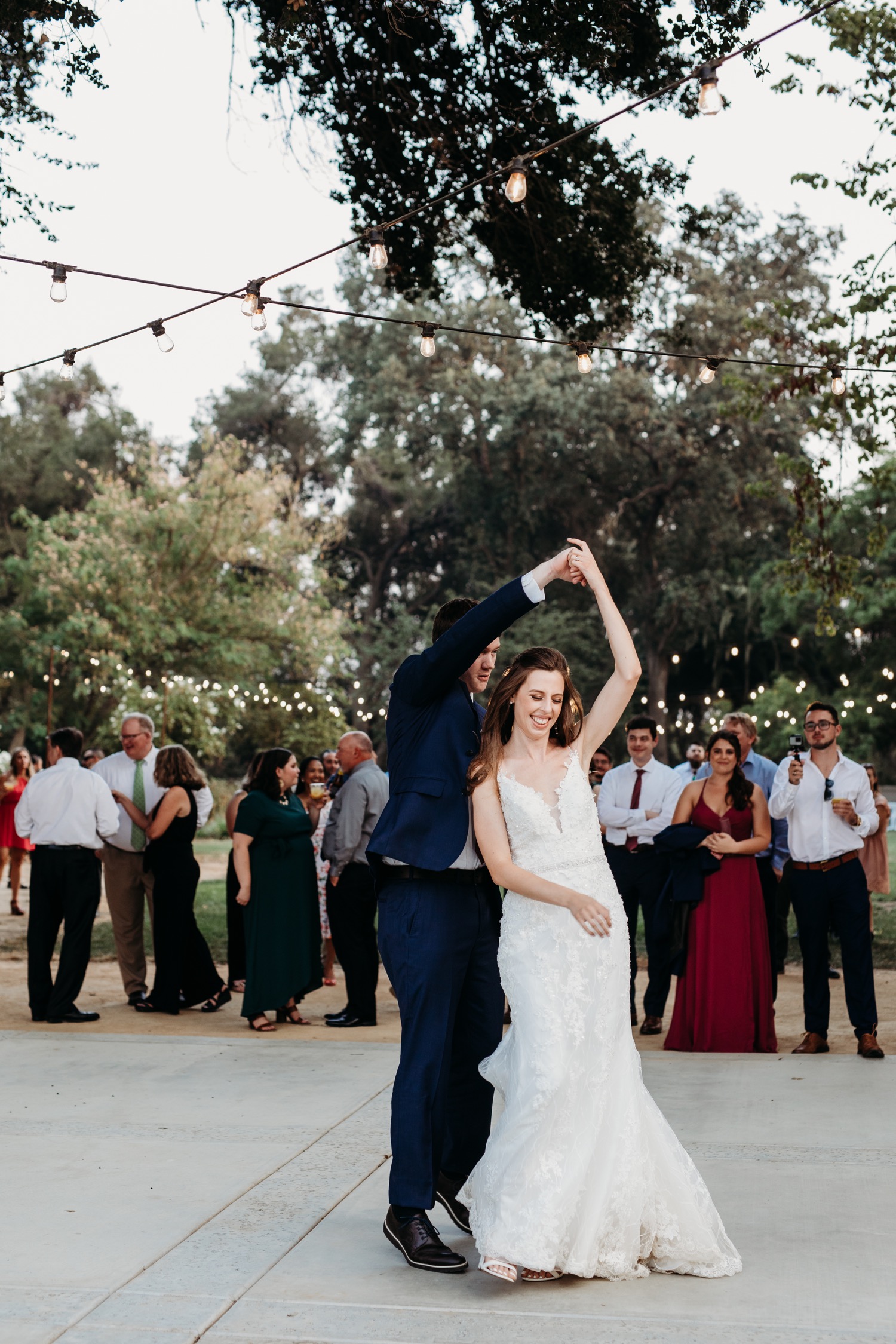 Bride and groom's first dance under the lights at The Maples in Woodland, CA