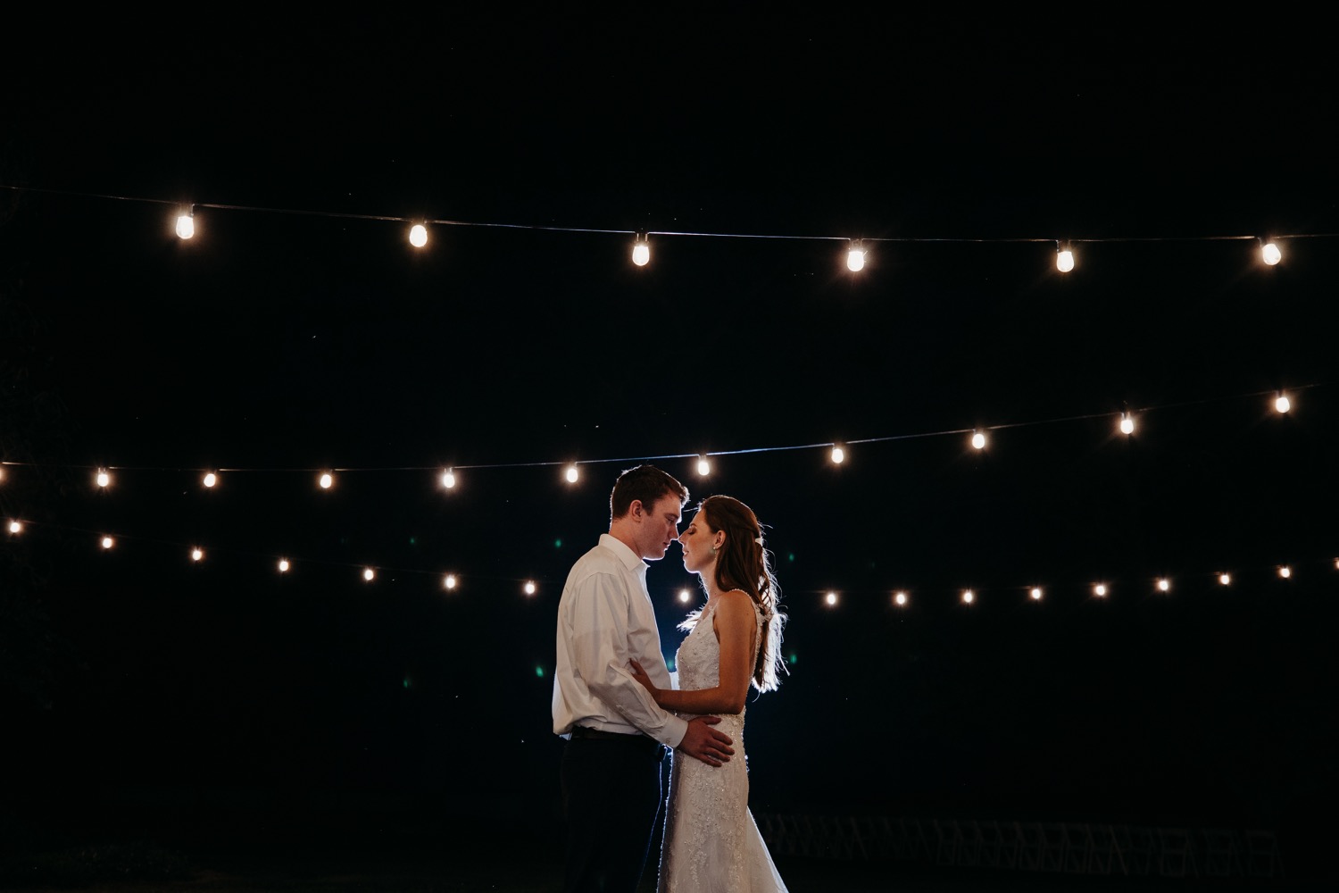 Bride and groom's final dance under the lights. Alayna and Trey's wedding at The Maples in Woodland, CA.