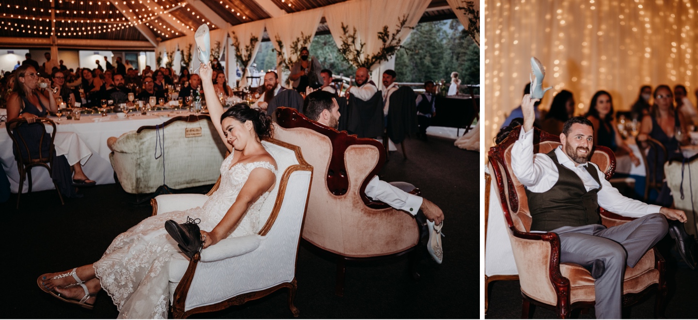 Bride and groom sit in chairs back to back holding the others shoe during their Yosemite wedding reception at Tenaya Lodge