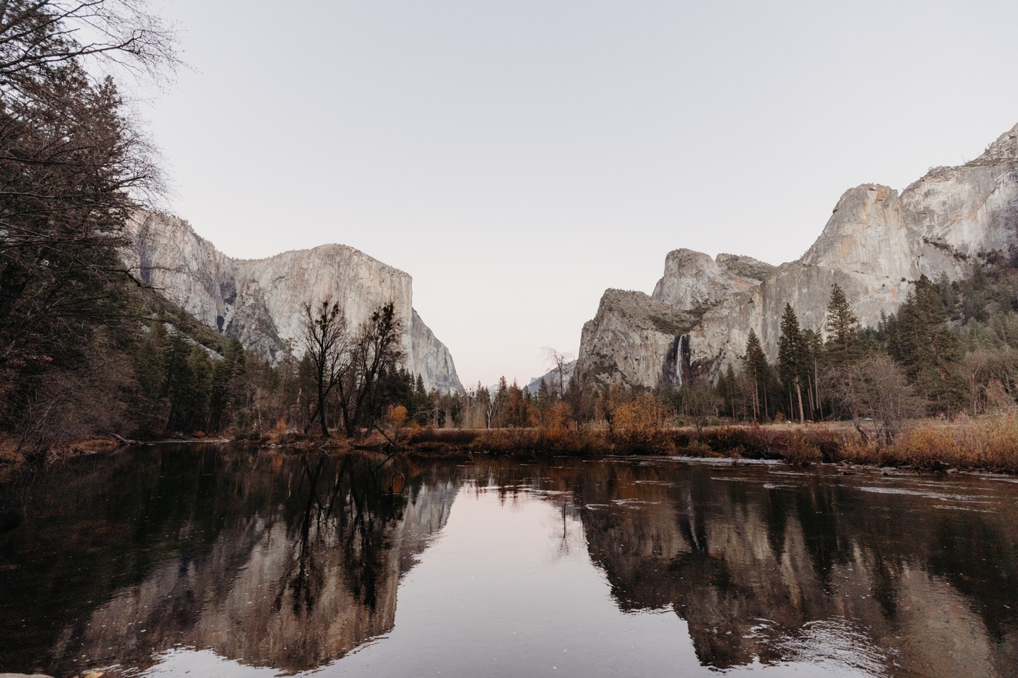 Yosemite's granite mountains reflected in a still lake in Yosemite National Park.