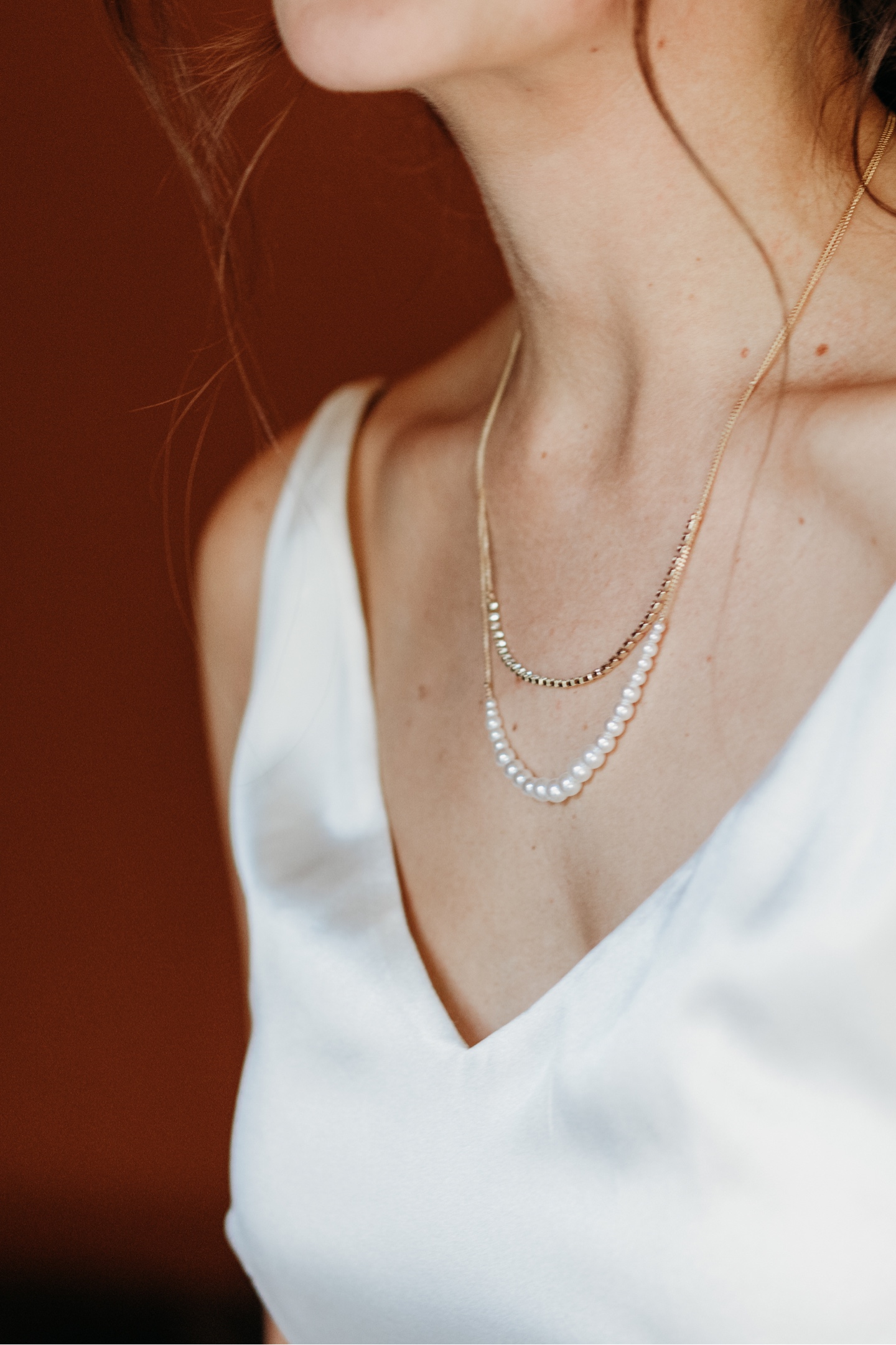 Close up of pearl and diamond necklace worn by the bride in her wedding dress. Sacramento wedding photography by Liz Koston.