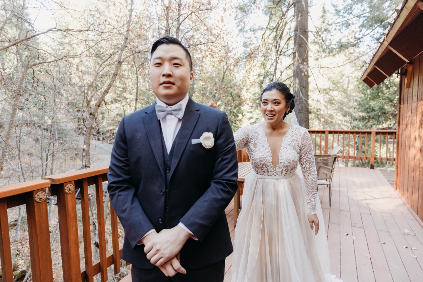 Bride taps the groom on the shoulder just for the first look before their Yosemite elopement.