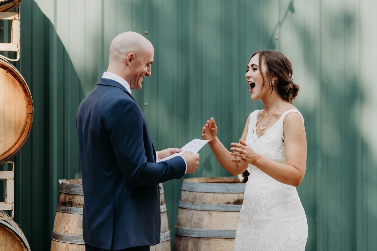 Bride laughs at something the groom wrote in his wedding letter to her. Wedding photography in Sacramento by Liz Koston.