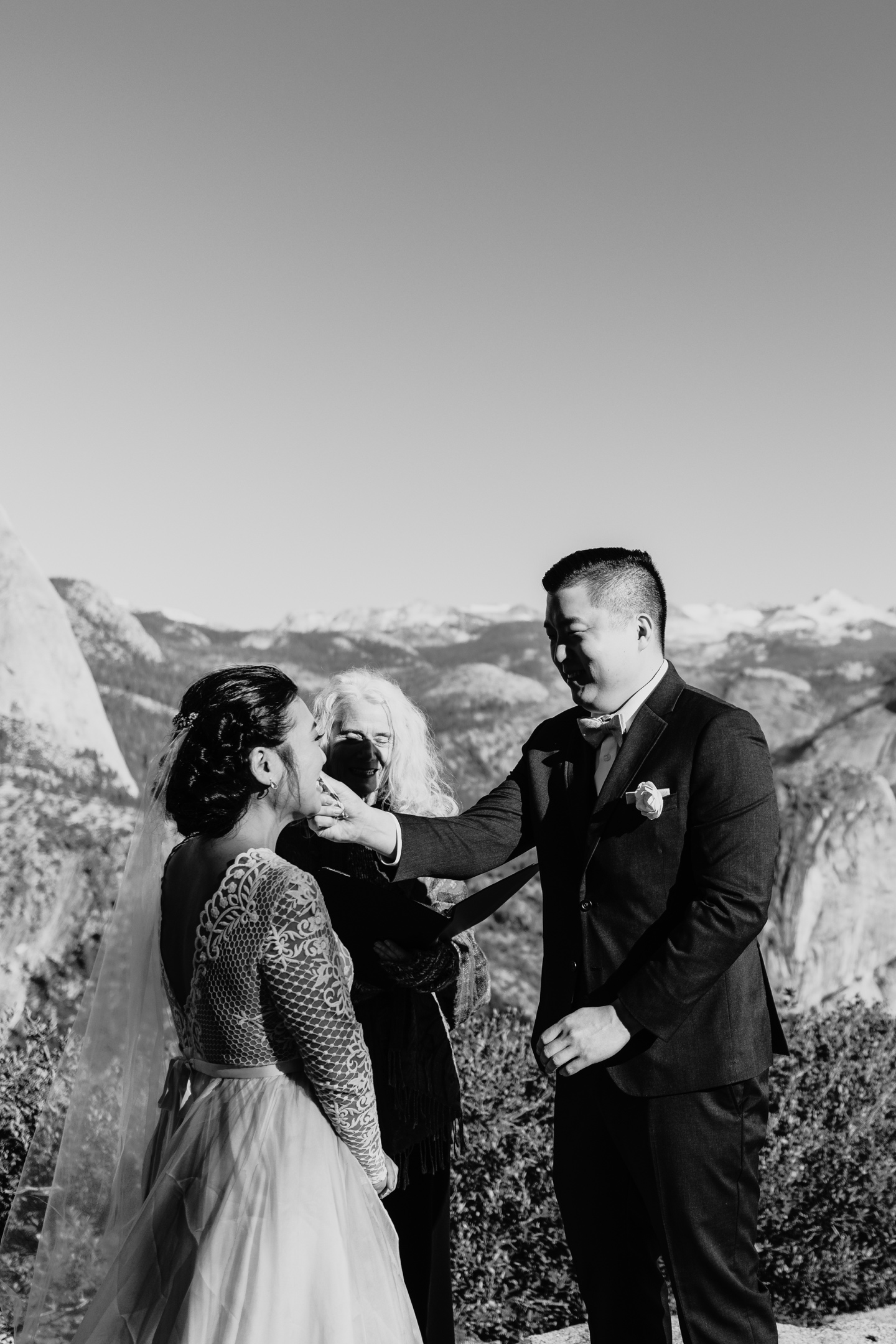 Groom dries his bride's eyes as they elope in Yosemite National Park