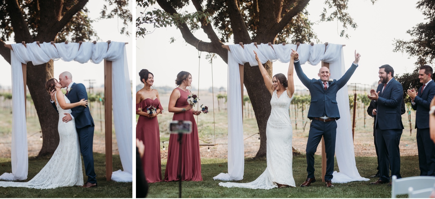 Bride and groom share their first kiss as husband and wife and throw arms up in celebration afterward Wedding photography in Sacramento by Liz Koston..