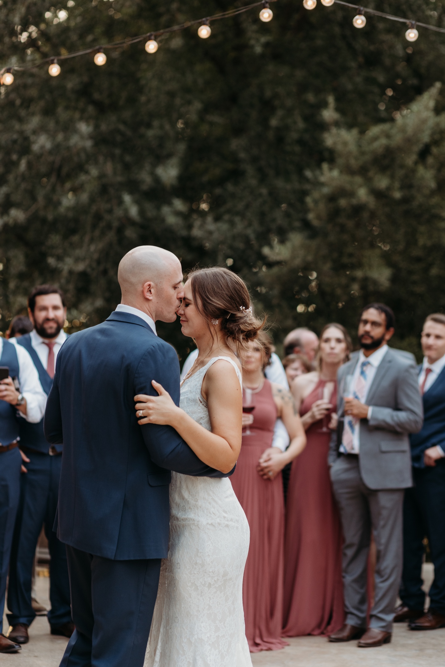 Groom kisses bride's forehead during their first dance at their wedding reception at Julietta winery in Sacramento, California.