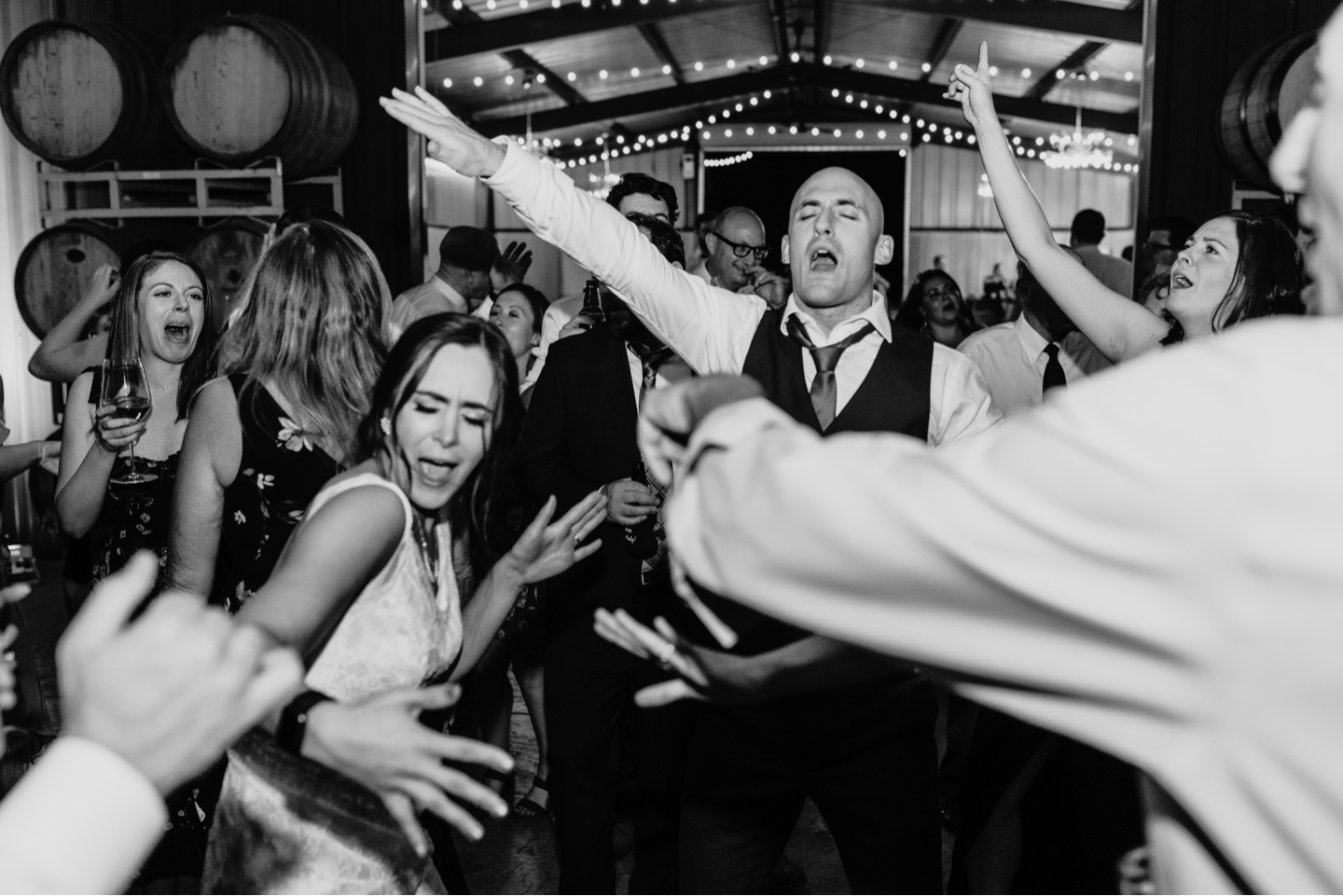 Bride and groom dance on the dance floor with their wedding guests. Wedding photography in Sacramento by Liz Koston.
