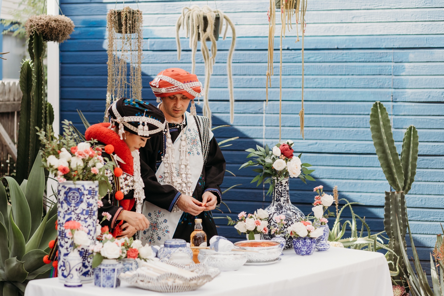 Bride and groom perform a traditional tea ceremony waring traditional Mian wedding attire at their Prickly Pear wedding.