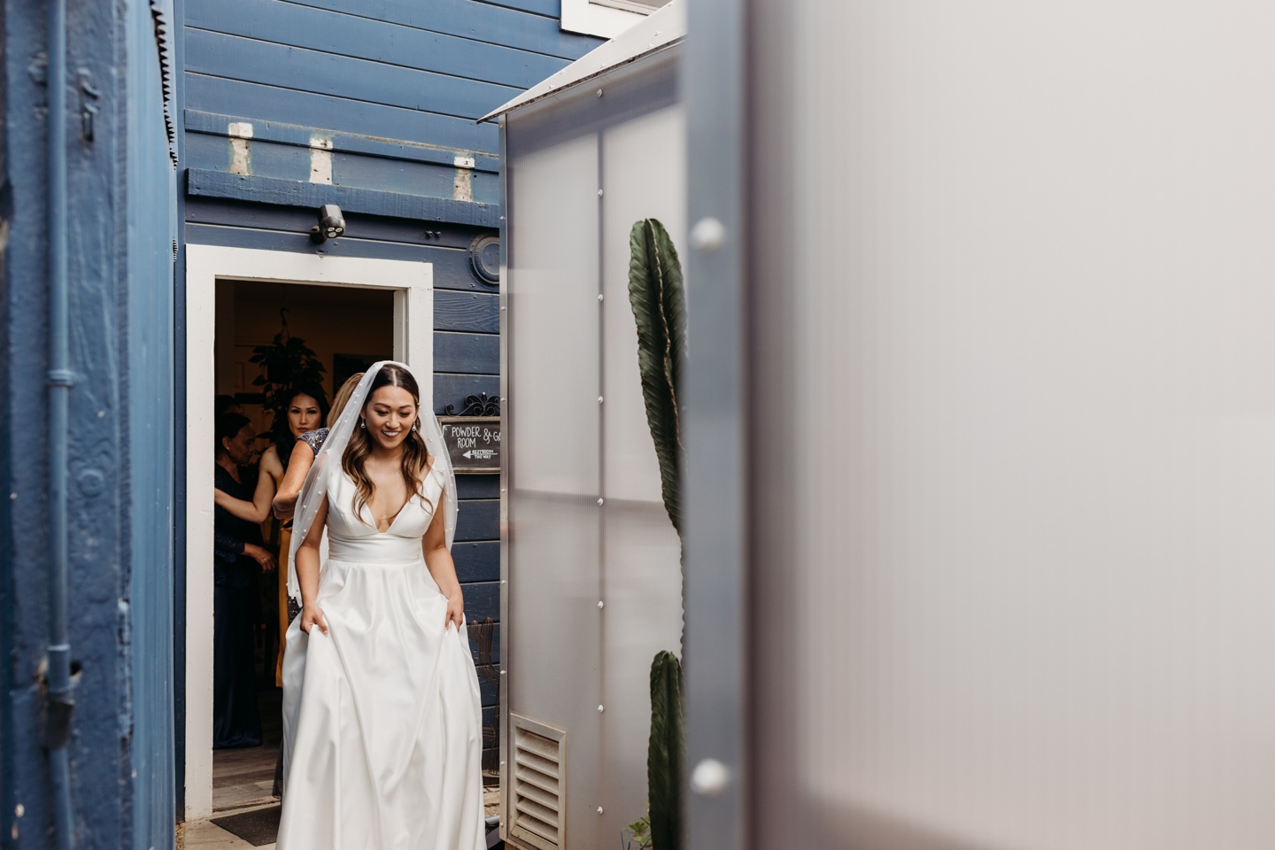 Bride walks out wearing her white wedding dress for her Prickly Pear wedding.