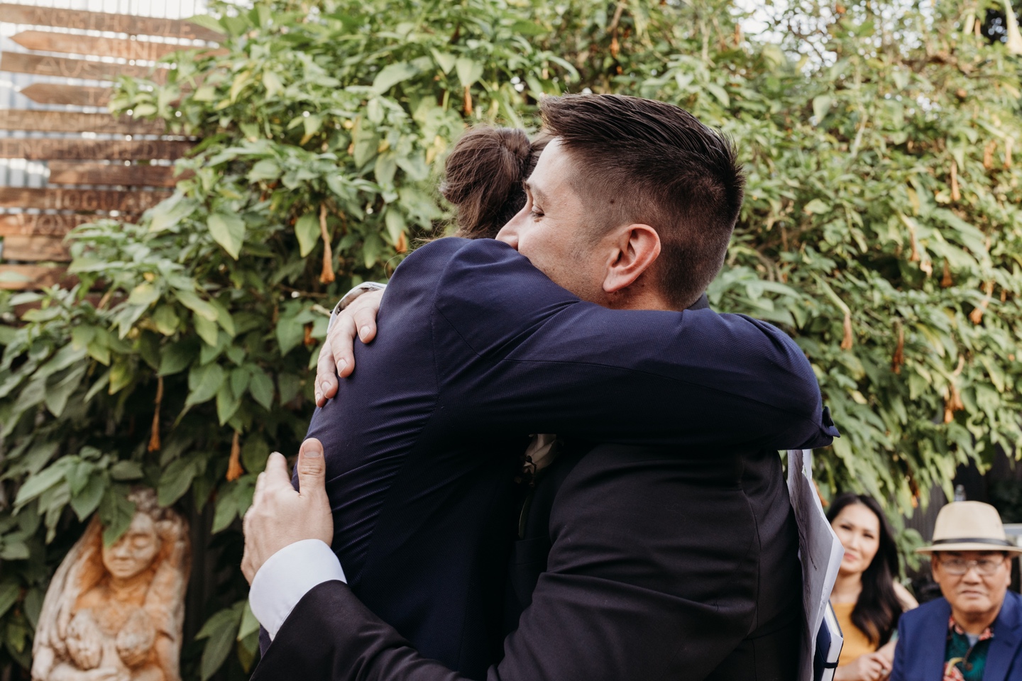 Groom hugs his friend and officiant before his Prickly Pear wedding.