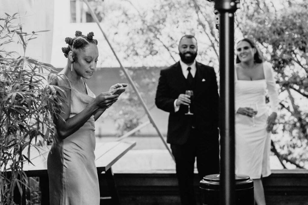 Woman gives speech to bride and groom during their intimate wedding reception. Photo by Liz Koston Photography.