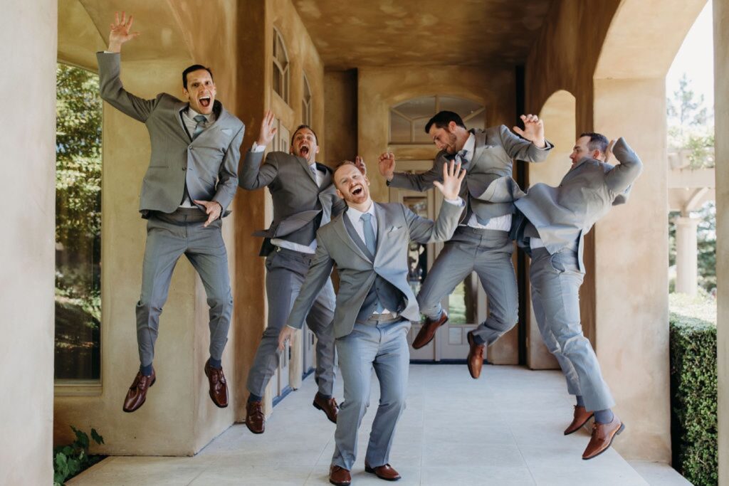 Groomsmen jumping in the air before the groom's Helwig Winery wedding. Liz Koston Photography.