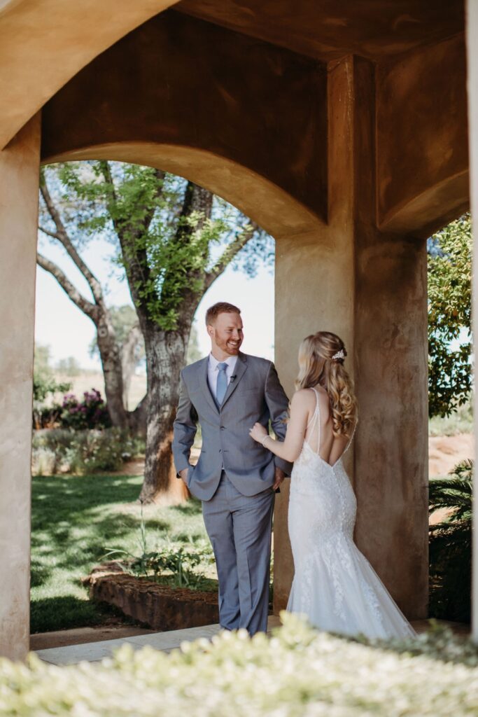 Groom turns to see his bride for the first time during their first look moment before their Helwig Winery wedding. Liz Koston Photography.