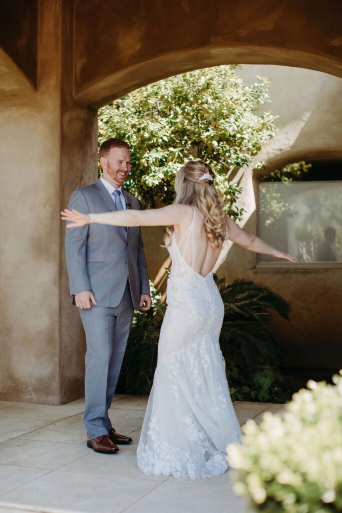 Bride shows off her wedding dress to her groom before their Helwig Winery wedding. Liz Koston Photography.