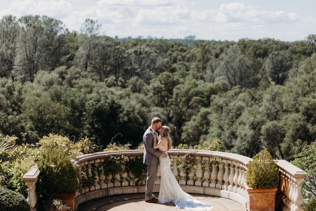 Bride and groom kiss at Helwig Winery balcony. Liz Koston Photography.