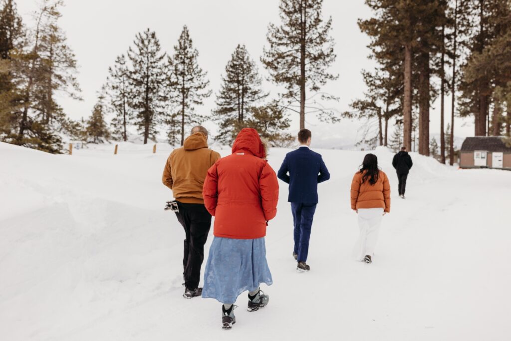 Family walks through the snow before a Lake Tahoe winter elopement. Liz Koston Photography.