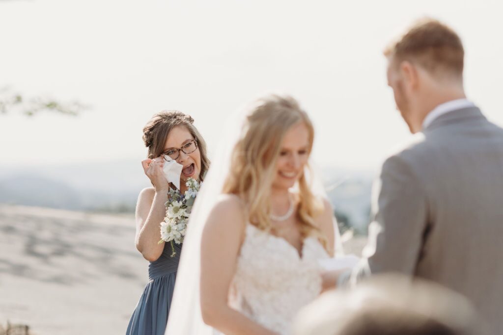 Guests dry their tears as the bride and groom get married. Liz Koston Photography.