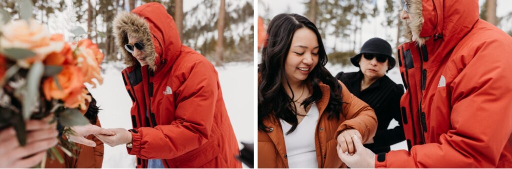 Guest wearing a puffy red winter coat  looks at the bride's wedding ring. Liz Koston Photography.